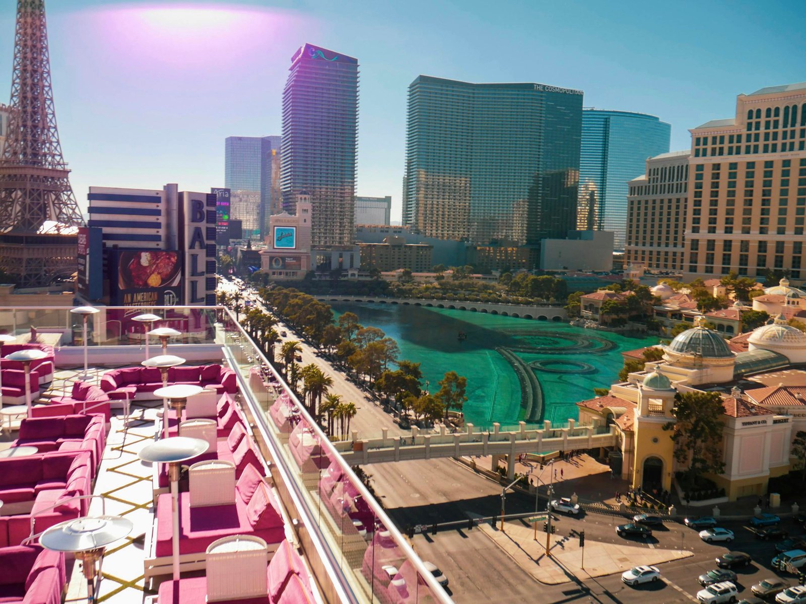 Stunning Las Vegas skyline featuring iconic landmarks like the Eiffel Tower replica and vibrant rooftop seating.
