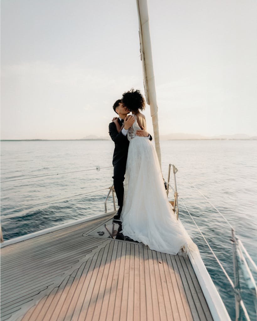 A couple embraces on a sailboat during their wedding in Catalunya, Spain.