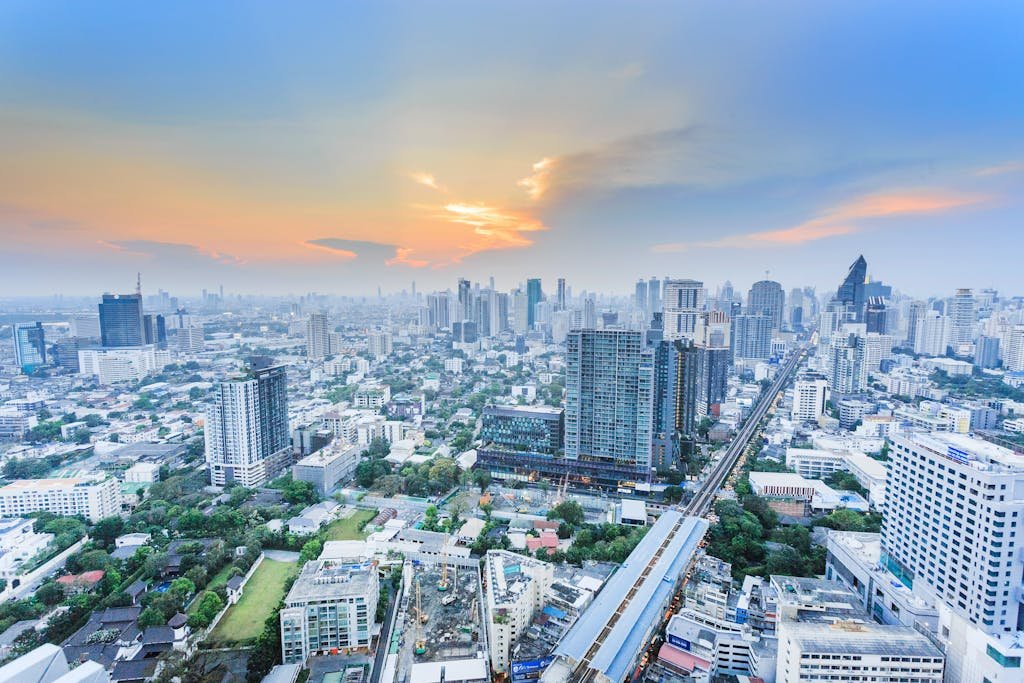 Stunning aerial view of Bangkok cityscape during twilight, showcasing the city's modern skyline.